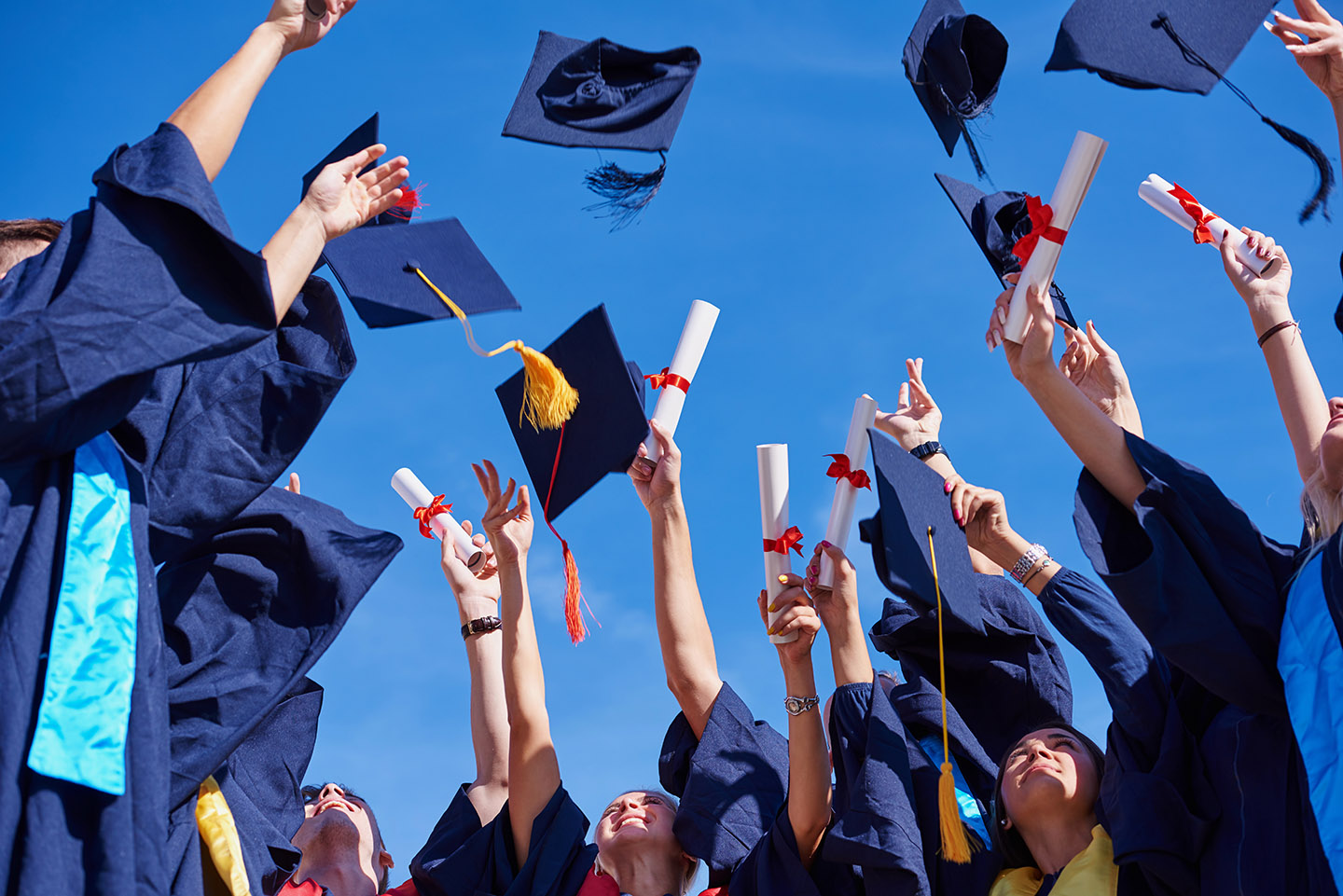 bottom view of graduations throwing cap